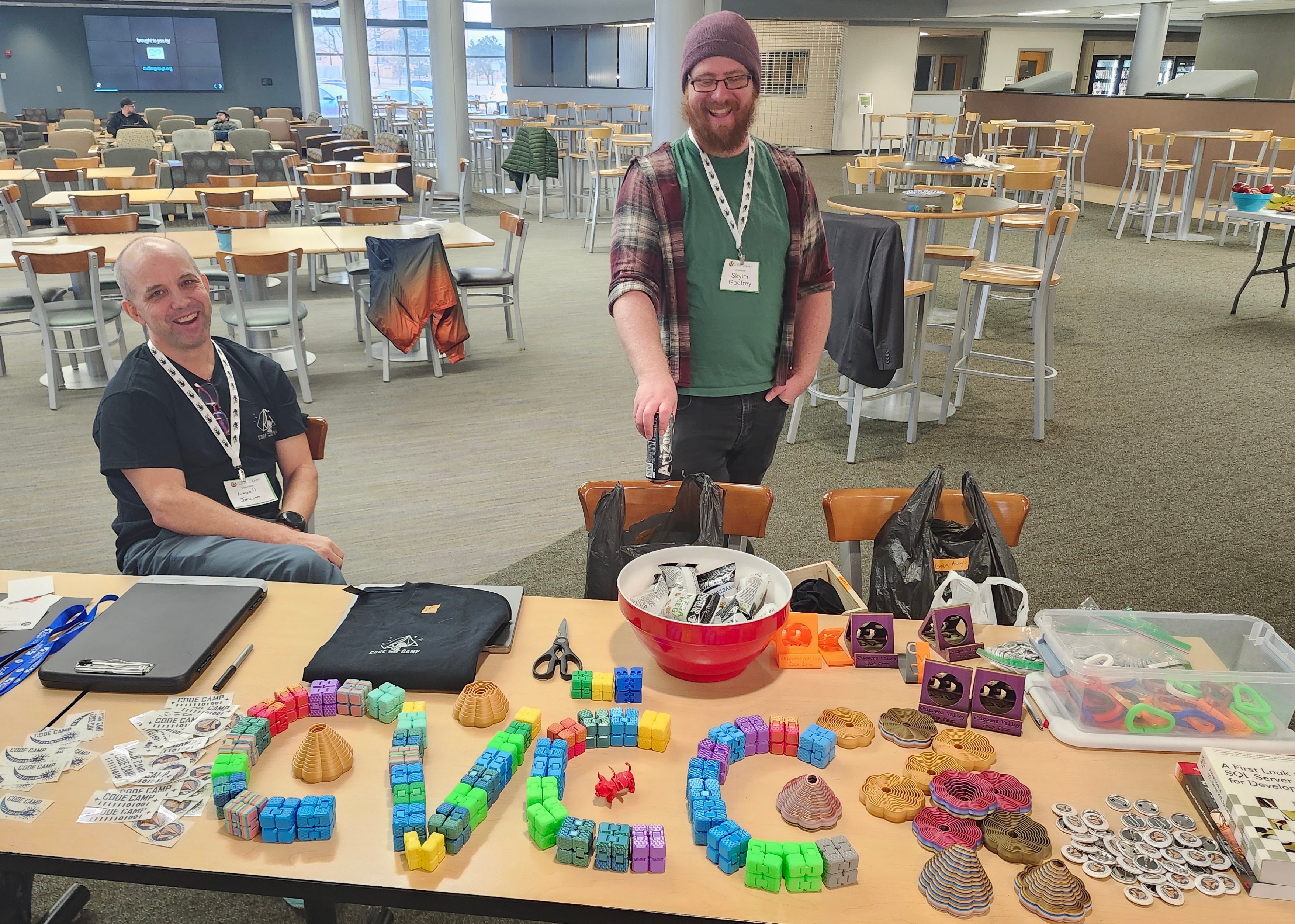 Lowell and Skyler at the registration table strewn with SWAG